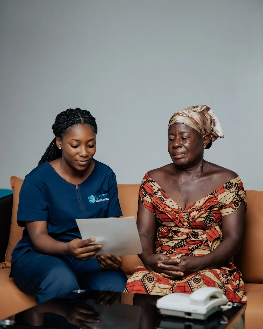 VMT nurse reviewing a written care summary with a patient at home