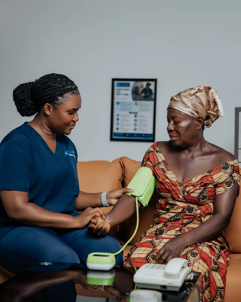 Healthcare worker supporting an elderly patient during an in-home care visit