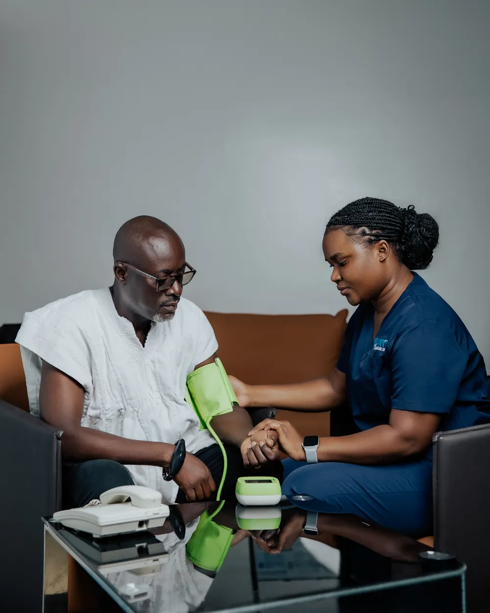 Nurse providing post-discharge recovery support during a home visit in Accra
